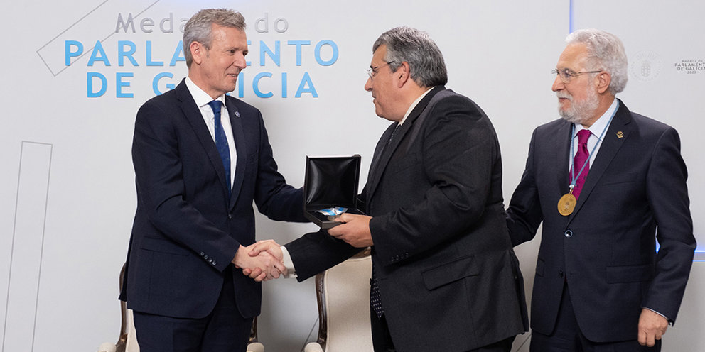 António Cunha, presidente da Eurorrexión, recibe de mans do presidente da Xunta, Alfonso Rueda, e acompañado polo presidente do Parlamento galego, Miguel Santalices, a medalla.